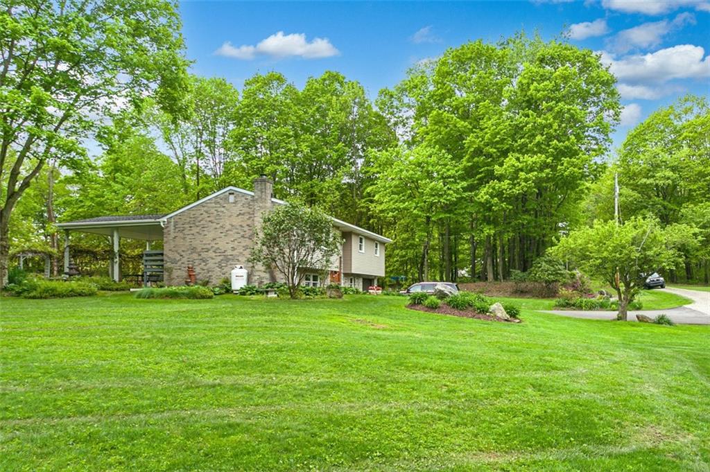 350 Apache Lane Apollo, PA 15613 - Photo 10 of 34 a yellow house sitting in middle of the forest