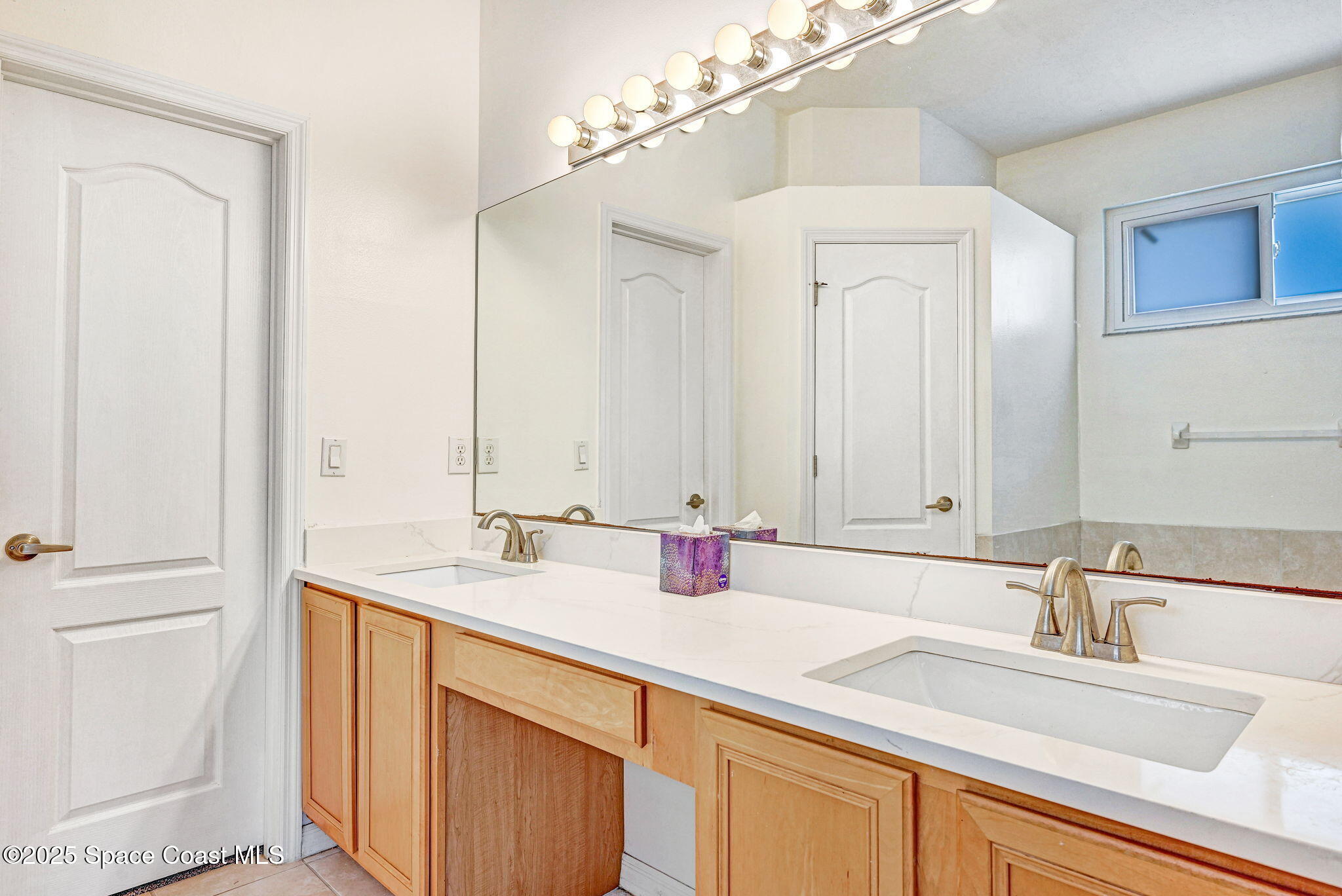 165 Calico Lane Indialantic, FL 32903 - Photo 12 of 25 a bathroom with a sink and a mirror