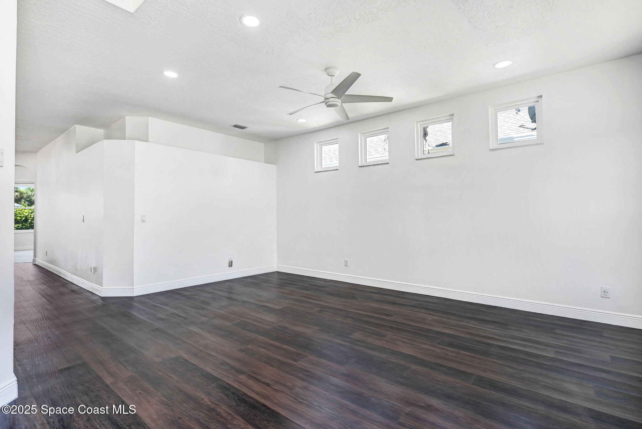 165 Calico Lane Indialantic, FL 32903 - Photo 3 of 25 an empty room with wooden floor and windows