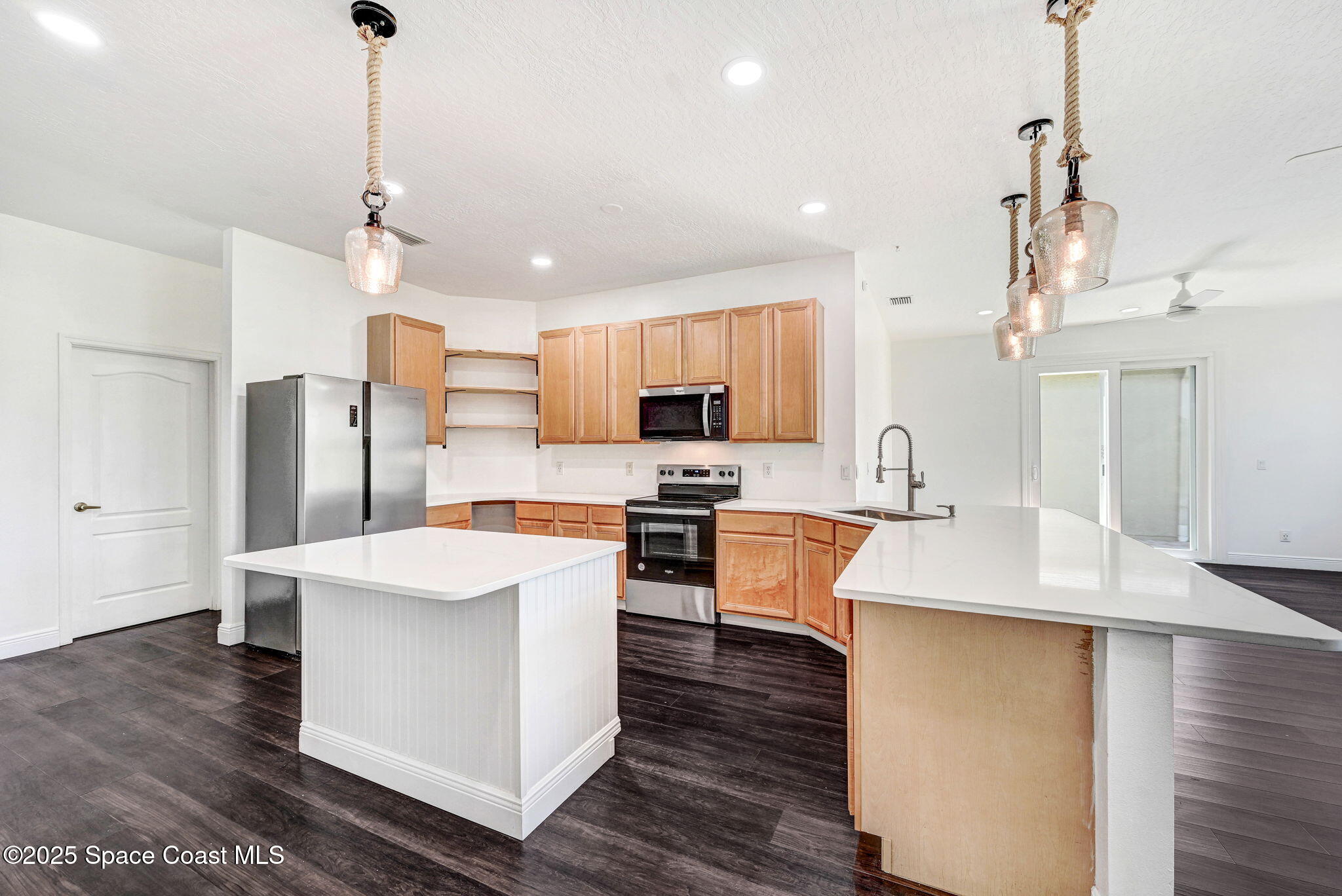 165 Calico Lane Indialantic, FL 32903 - Photo 7 of 25 a large kitchen with stainless steel appliances sink refrigerator and cabinets