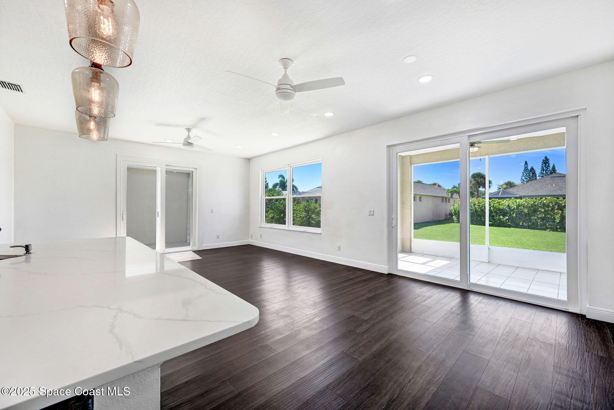 165 Calico Lane Indialantic, FL 32903 - Photo 9 of 25 a view of an empty room with wooden floor and a window