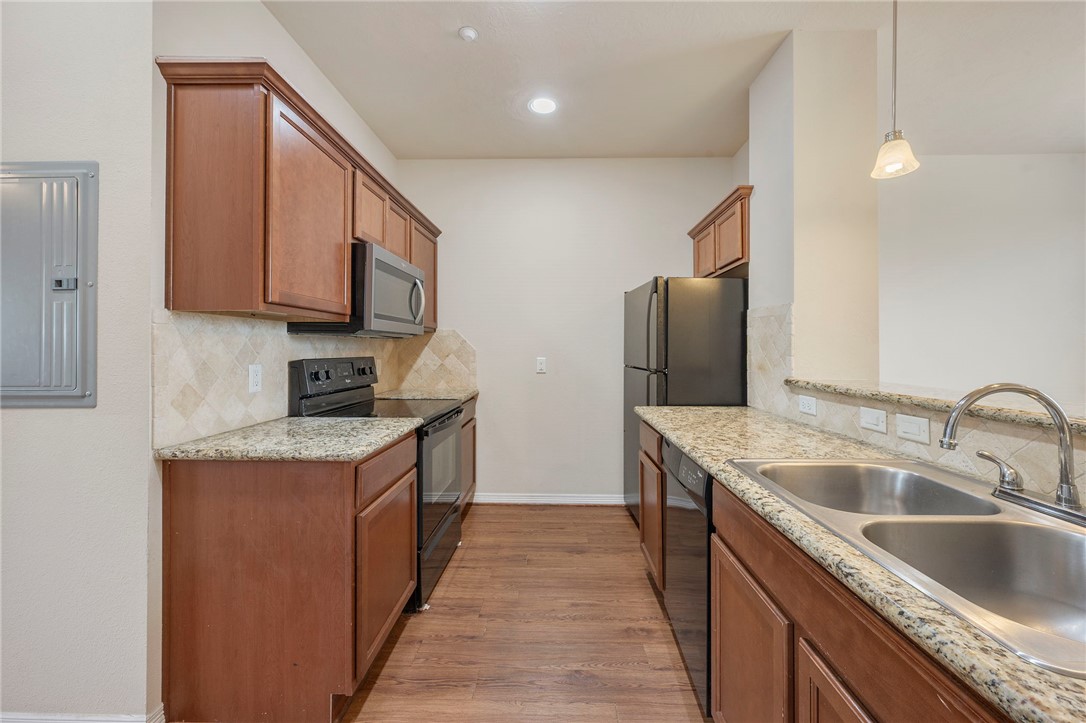 1198 Jones-Butler Road, Unit 2108 College Station, TX 77840 - Photo 2 of 10 a kitchen with stainless steel appliances granite countertop a sink and a refrigerator