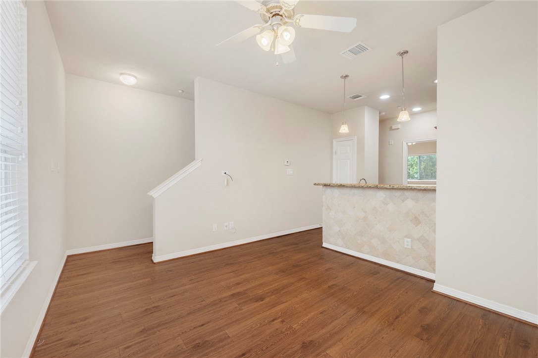 1198 Jones-Butler Road, Unit 2108 College Station, TX 77840 - Photo 4 of 10 an empty room with wooden floor and windows