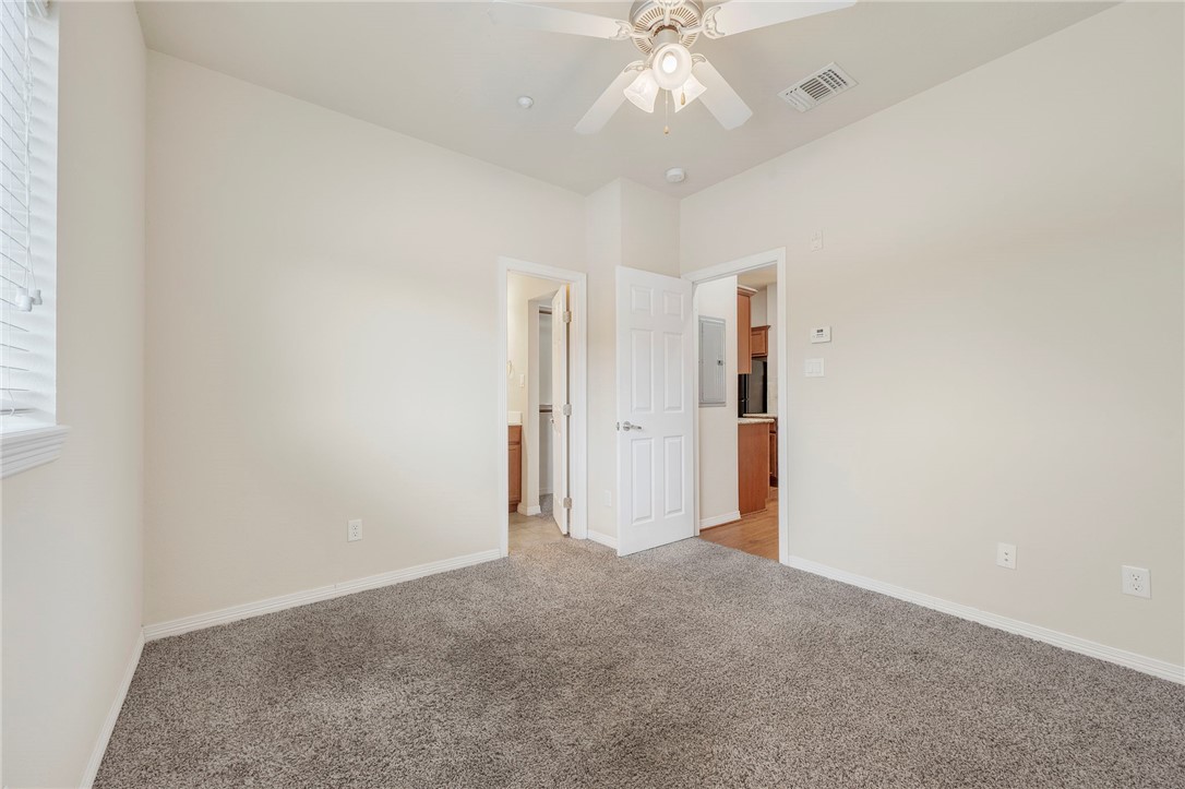 1198 Jones-Butler Road, Unit 2108 College Station, TX 77840 - Photo 5 of 10 an empty room with a chandelier fan and closet