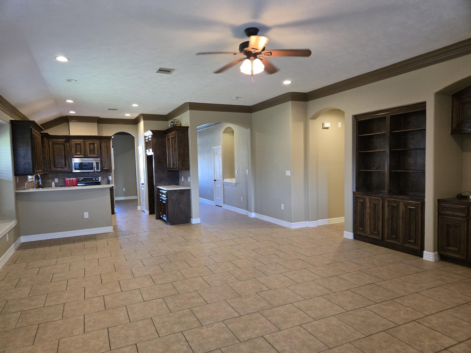 306 Masterson Street Arcola, TX 77583 - Photo 14 of 28 an empty room with kitchen and a chandelier