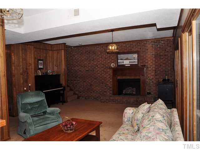 7528 Fiesta Way Raleigh, NC 27615 - Photo 12 of 22 a living room with furniture and a fireplace
