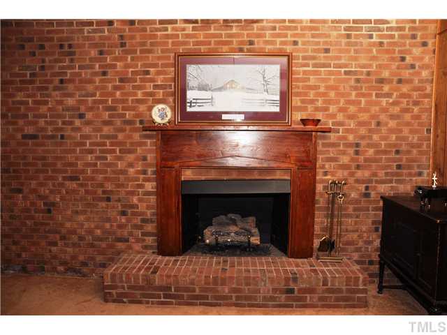 7528 Fiesta Way Raleigh, NC 27615 - Photo 13 of 22 a living room with a fireplace