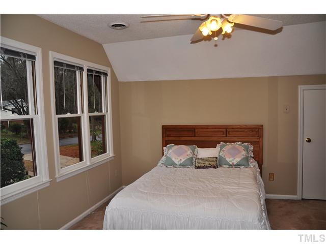 7528 Fiesta Way Raleigh, NC 27615 - Photo 16 of 22 a bedroom with a bed and a window