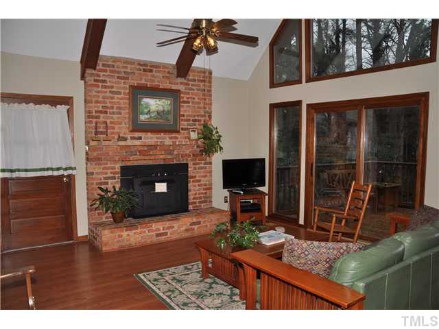 7528 Fiesta Way Raleigh, NC 27615 - Photo 3 of 22 a living room with furniture a flat screen tv and a fireplace