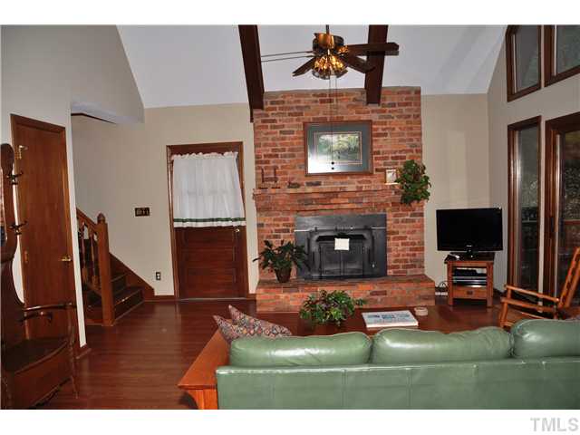 7528 Fiesta Way Raleigh, NC 27615 - Photo 5 of 22 a living room with furniture a flat screen tv and a fireplace