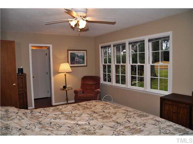 7528 Fiesta Way Raleigh, NC 27615 - Photo 9 of 22 a bedroom with a bed dresser and a window