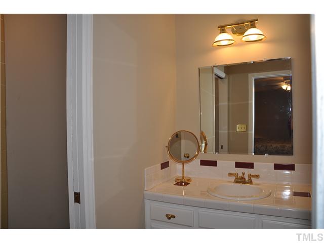 7528 Fiesta Way Raleigh, NC 27615 - Photo 10 of 22 a bathroom with a sink and a mirror