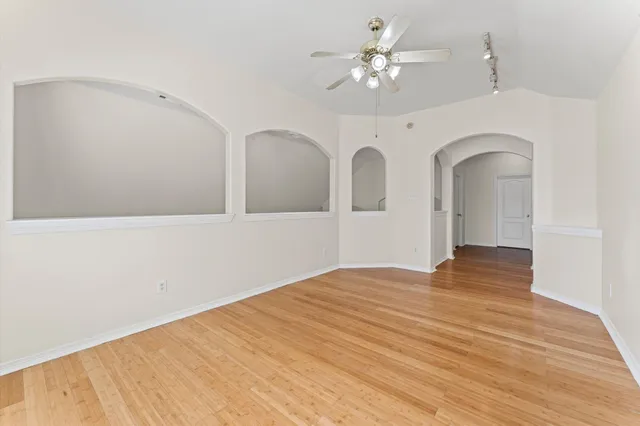 a view of empty room with wooden floor