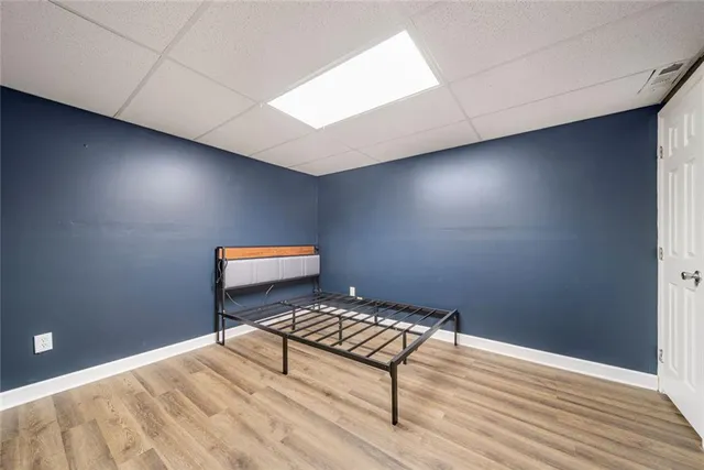 a view of a room with wooden floor and chair