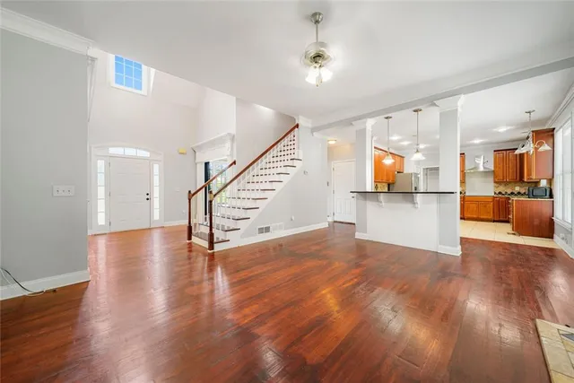 a view of a kitchen with furniture and wooden floor
