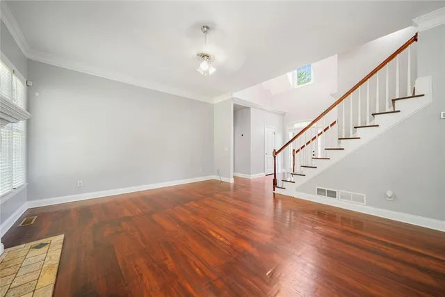 a view of entryway and hall with wooden floor