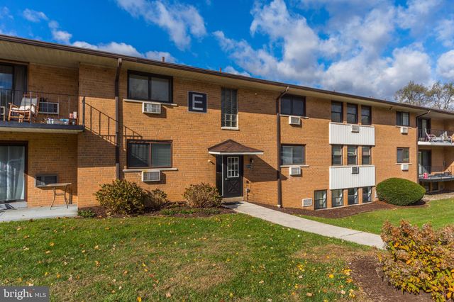 a backyard of a house with lots of green space and outdoor seating