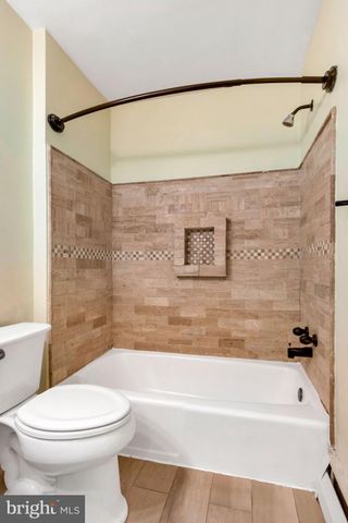 a bathroom with a toilet and a bathtub