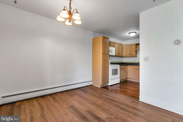 a kitchen with wooden floors and refrigerator