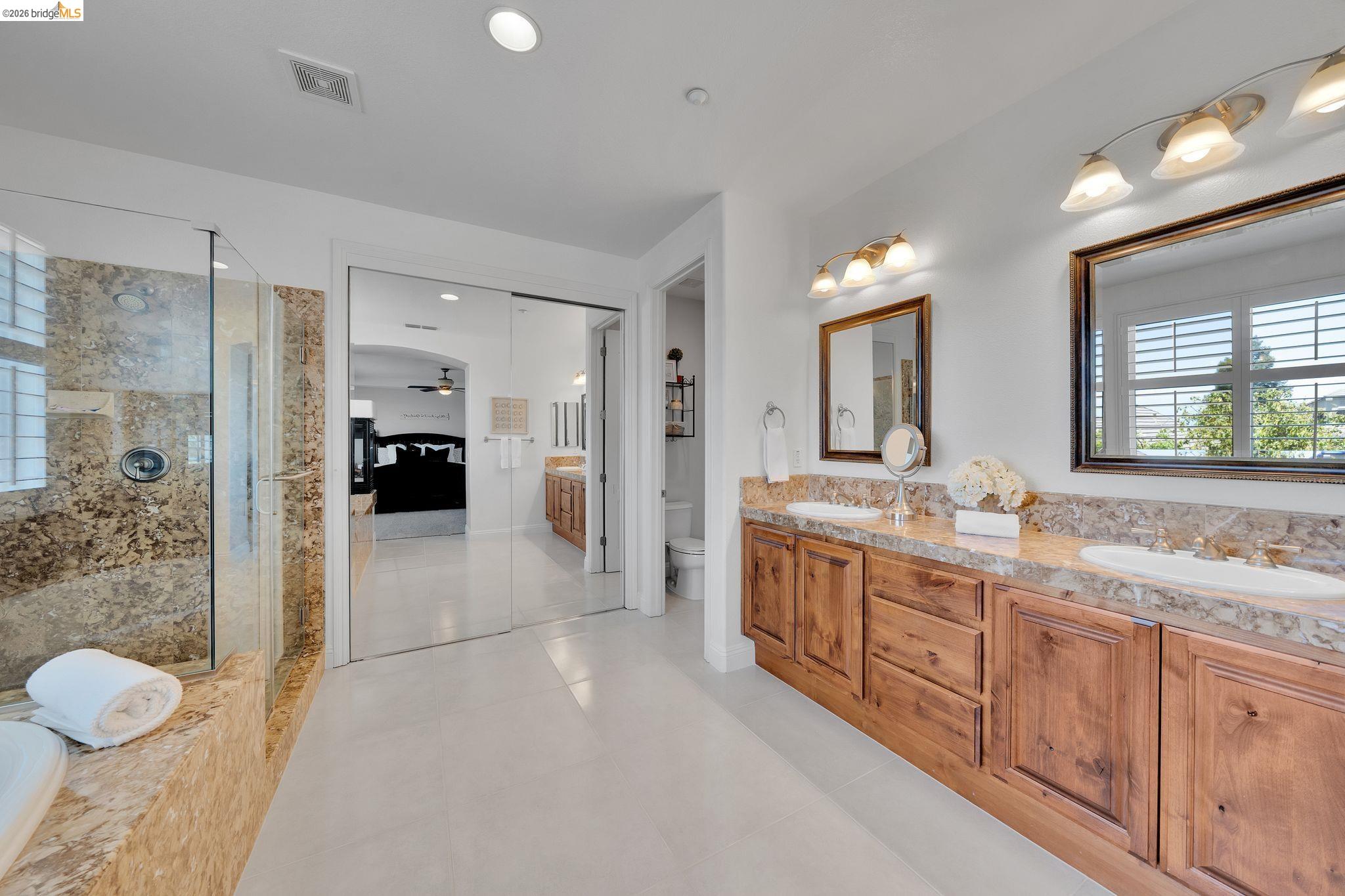 2513 Winged Foot Road Brentwood, CA 94513 - Photo 19 of 45 Double vanity with rich wood cabinetry and stone countertops