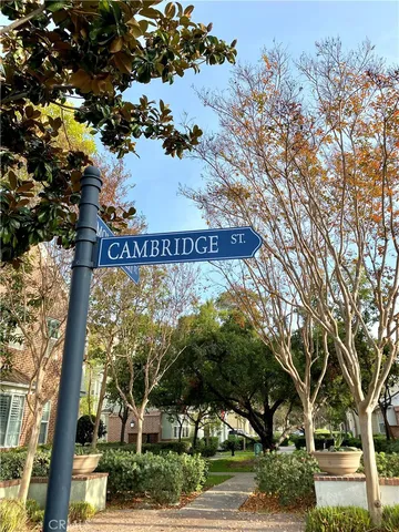 a view of a sign in a yard with large trees