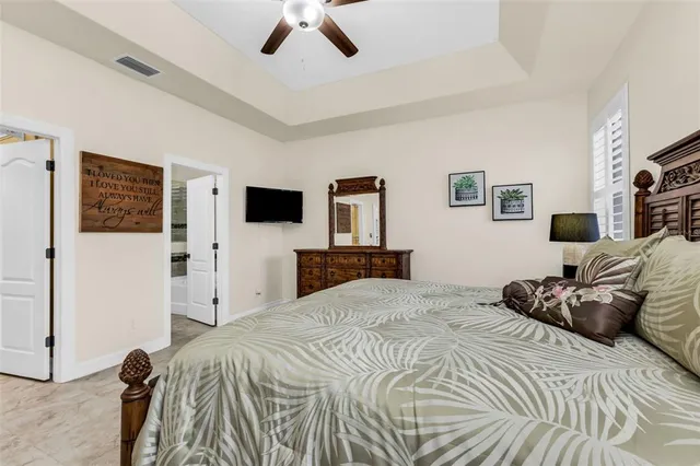 a bathroom with a granite countertop sink a mirror and shower