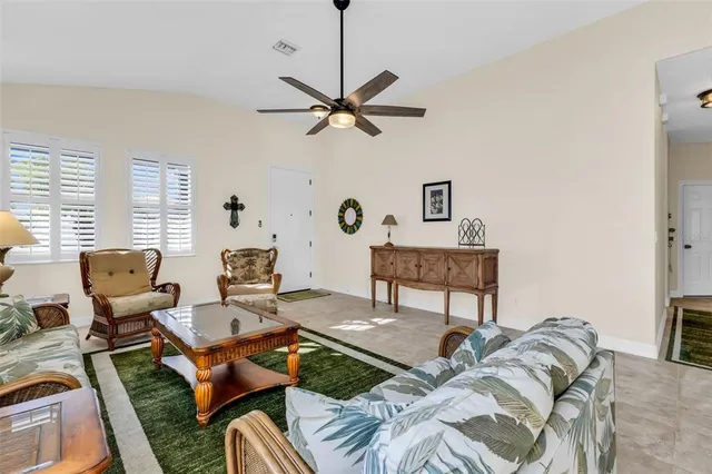 a kitchen with stainless steel appliances kitchen island granite countertop a sink and a refrigerator