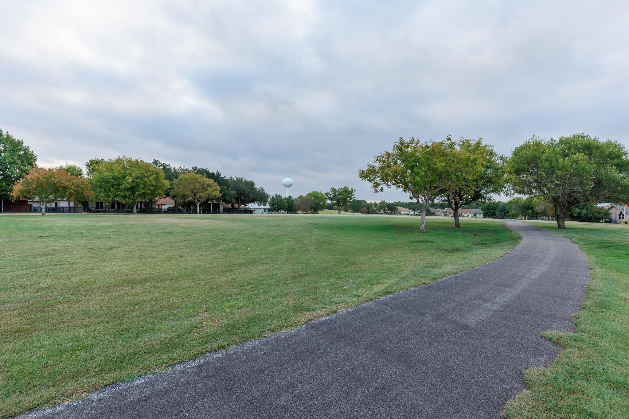Lot 150-21b Muirfield Marble Falls, TX 78654 - Photo 8 of 8 a view of a grassy field with trees in the background