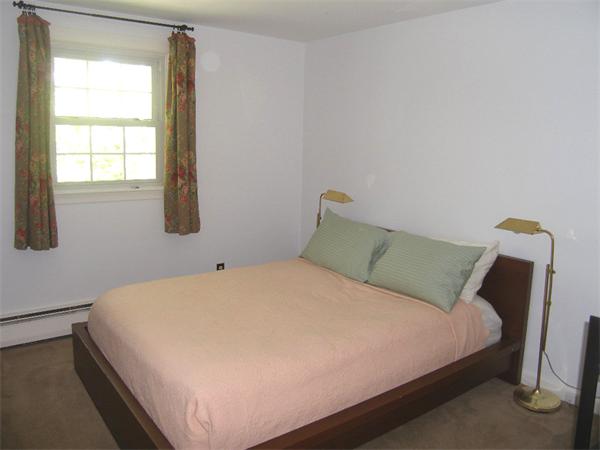 25 Jeffrey Road Wayland, MA 01778 - Photo 12 of 16 a large bed sitting in a bedroom next to a window