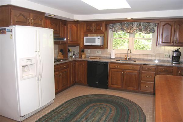 25 Jeffrey Road Wayland, MA 01778 - Photo 3 of 16 a kitchen with granite countertop a sink stainless steel appliances and window