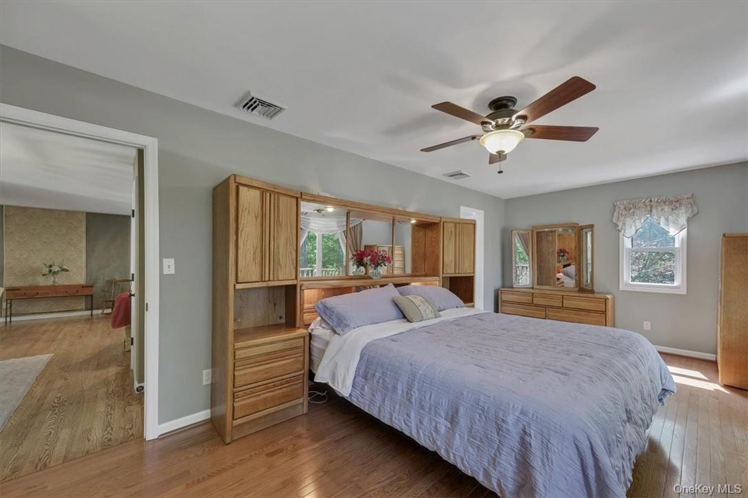 13 Split Rock Road Mahopac, NY 10541 - Photo 14 of 36 a bedroom with a large bed and a chandelier