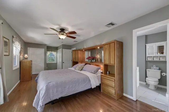 a bed room with a bed and a ceiling fan