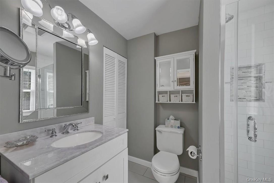 13 Split Rock Road Mahopac, NY 10541 - Photo 17 of 36 a bathroom with a sink a toilet and a mirror