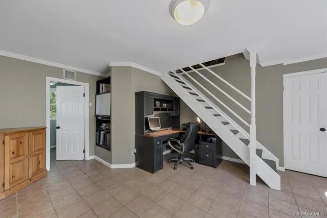 a view of livingroom with furniture and workspace