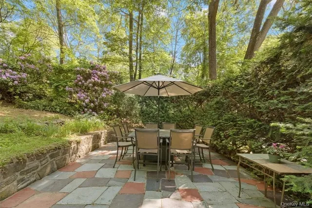 a lawn chair sitting under a blue umbrella