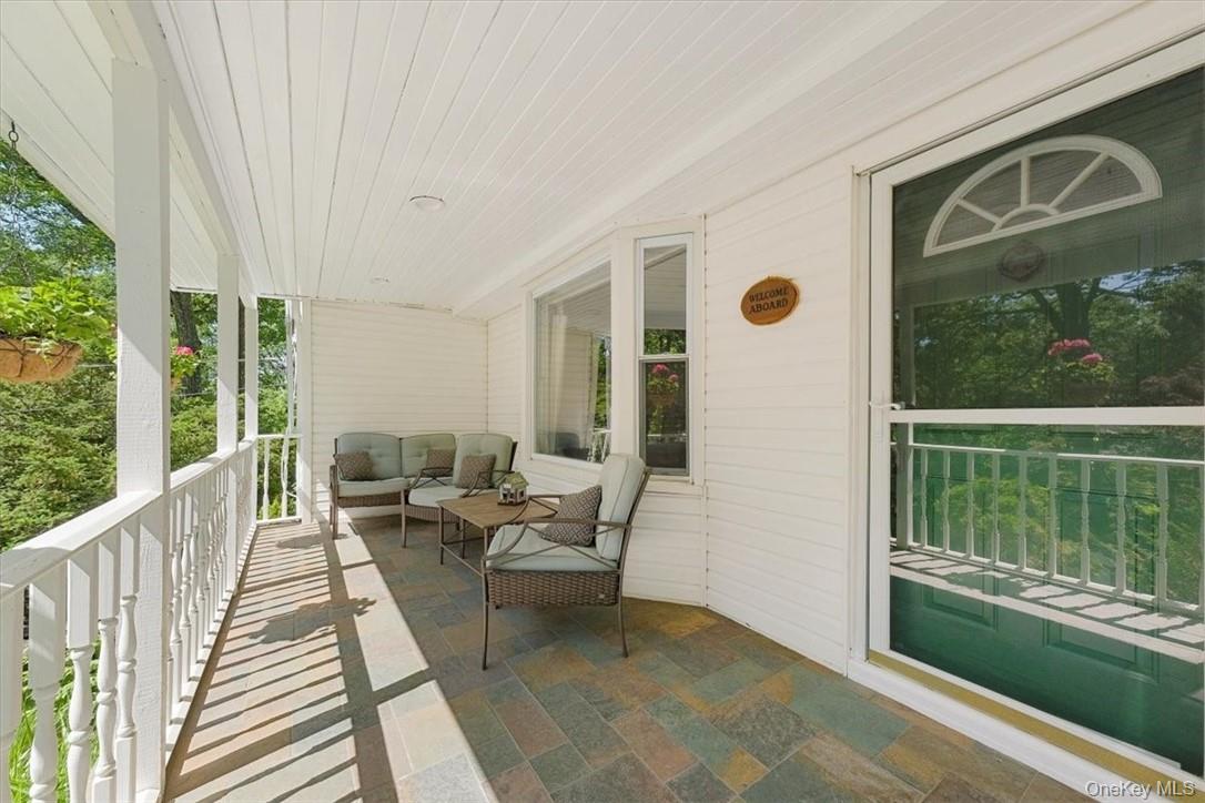 13 Split Rock Road Mahopac, NY 10541 - Photo 4 of 36 a balcony with chairs and wooden floor