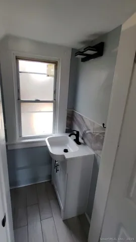 a bathroom with a sink a vanity and window