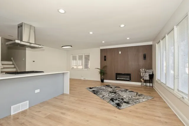 a kitchen with stainless steel appliances granite countertop a sink stove and cabinets