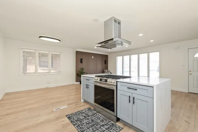 a kitchen with granite countertop a stove and a sink