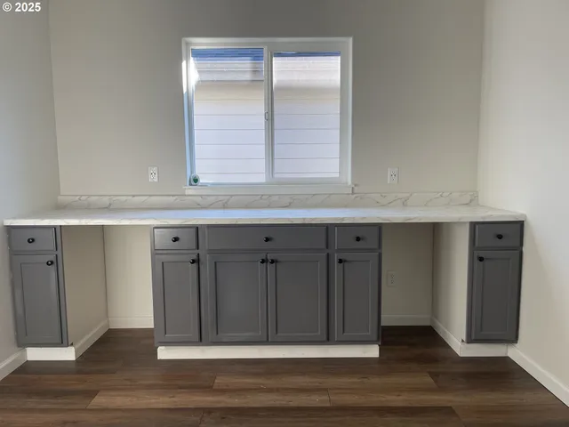 an empty room with wooden floor