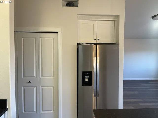 a view of a refrigerator in kitchen