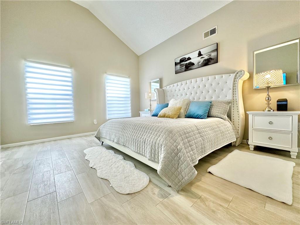 3639 Kent Drive Naples, FL 34112 - Photo 27 of 40 a bedroom with a bed and a cabinets