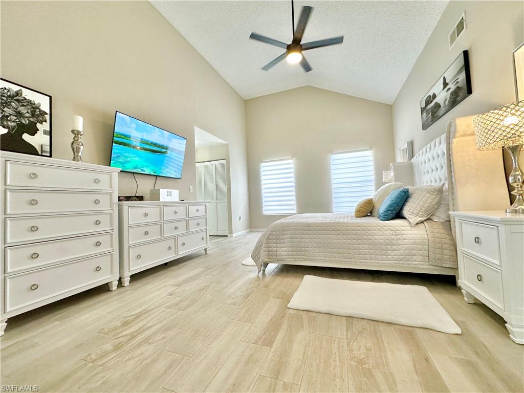 3639 Kent Drive Naples, FL 34112 - Photo 30 of 40 a spacious bedroom with a bed a dresser and a window