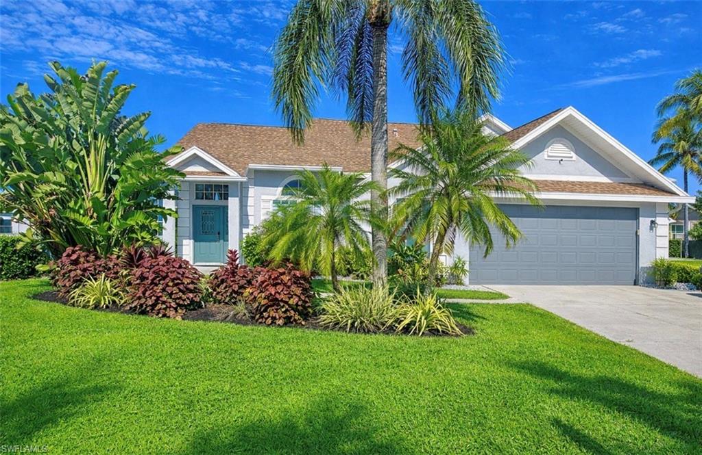 3639 Kent Drive Naples, FL 34112 - Photo 3 of 40 a front view of house with a garden