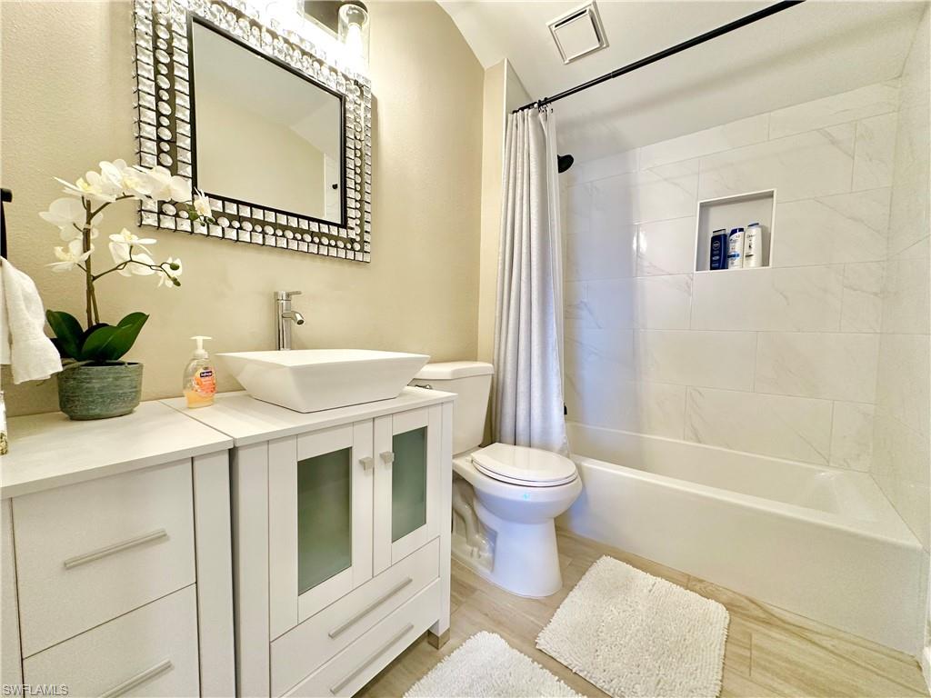 3639 Kent Drive Naples, FL 34112 - Photo 35 of 40 a bathroom with a sink a toilet and shower