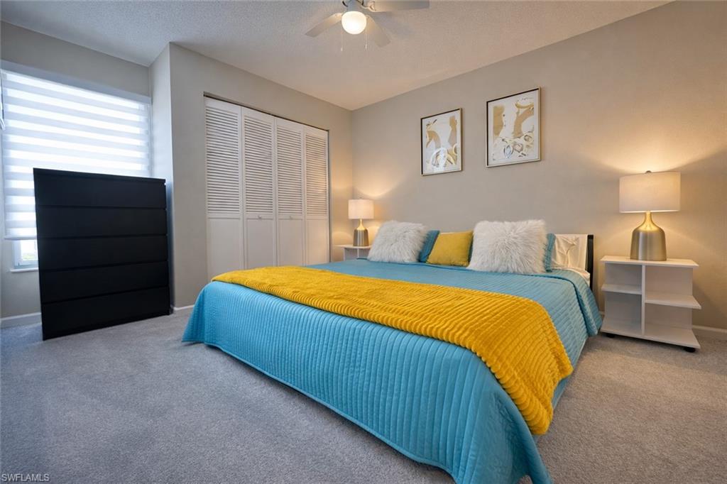 3639 Kent Drive Naples, FL 34112 - Photo 37 of 40 a bedroom with a bed and a lamp on dresser