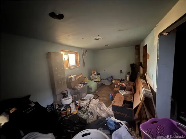 a living room with furniture chess board and a window