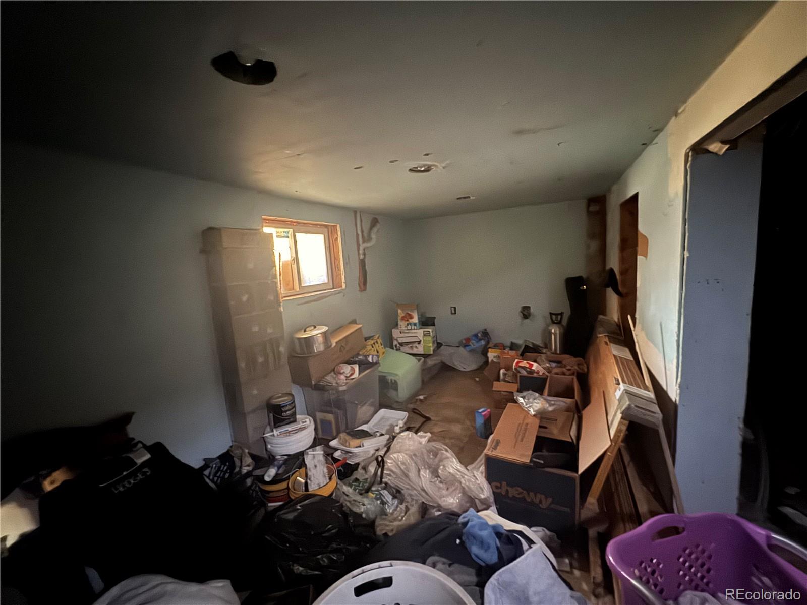 4568 Apex Valley Road Idaho Springs, CO 80452 - Photo 18 of 29 a living room with furniture chess board and a window