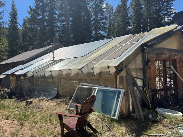 a backyard of a house with table and chairs