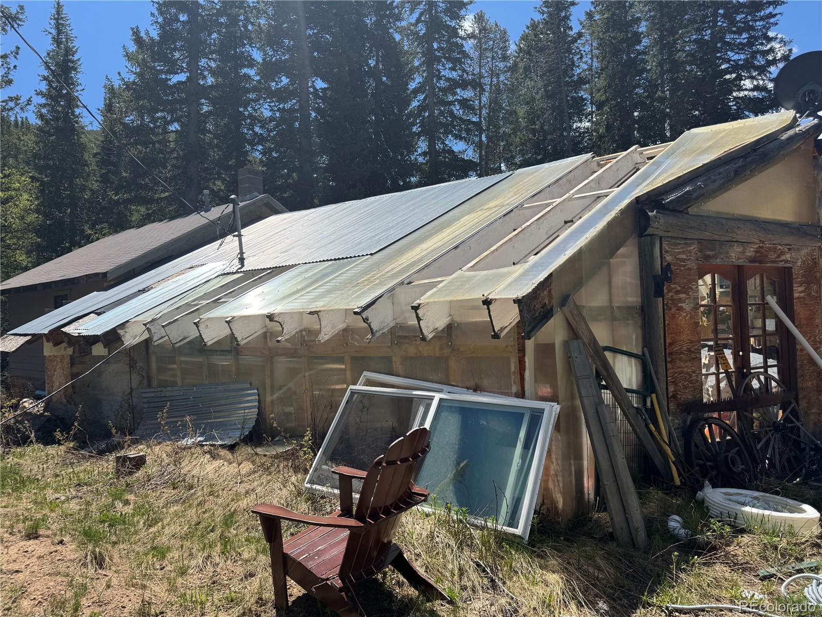 4568 Apex Valley Road Idaho Springs, CO 80452 - Photo 20 of 29 a backyard of a house with table and chairs